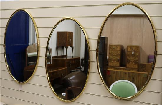 Three brass framed oval mirrors H.80cm